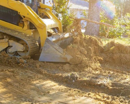 Bulldozer scoop working on the excavation works of moving earth