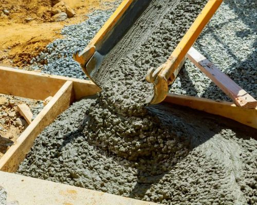 Construction of a concrete walkway around a residential rural house in manual of the pavement with a