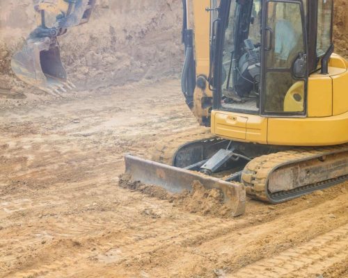 Workplace construction excavator on foundation works is prepared for pouring the foundation